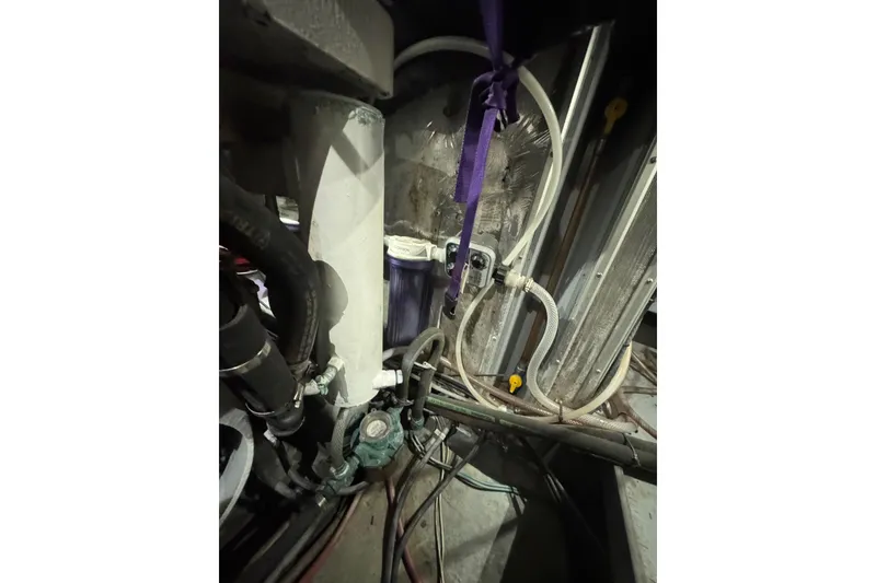 Slide: The Image of Engine room of a 1995 Nordhavn 46 yacht, showcasing pipes and mechanical components. - 43