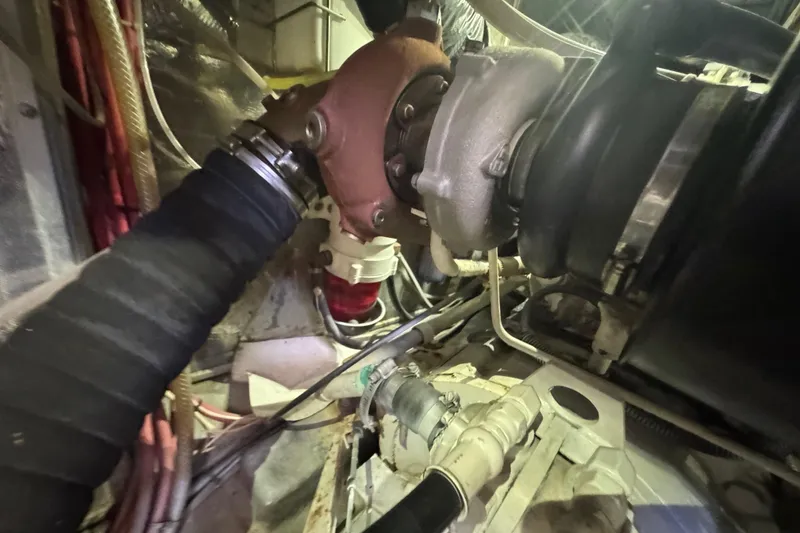 Slide: The Image of Engine room of a 1995 Nordhavn 46 yacht, showcasing mechanical components and hoses. - 47