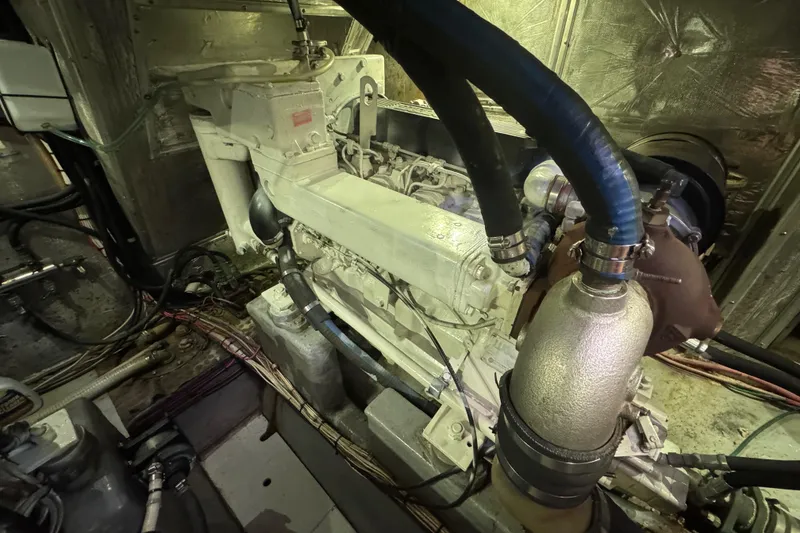Slide: The Image of Engine room of a 1995 Nordhavn 46 yacht, showcasing mechanical components and wiring. - 49
