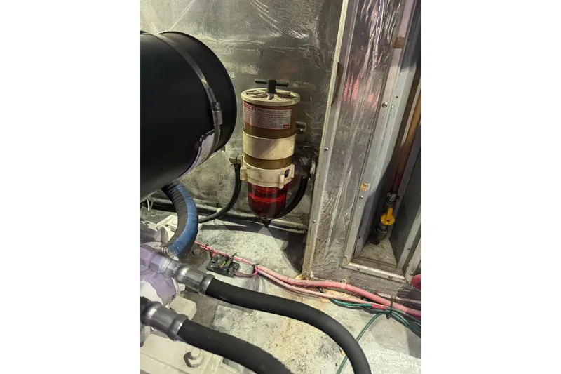 Slide: The Image of Engine room of a 1995 Nordhavn 46 yacht, featuring fuel filter and hoses. - 51