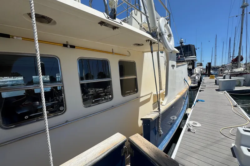 Slide: The Image of 1995 Nordhavn 46 yacht docked at marina under clear blue sky. - 7
