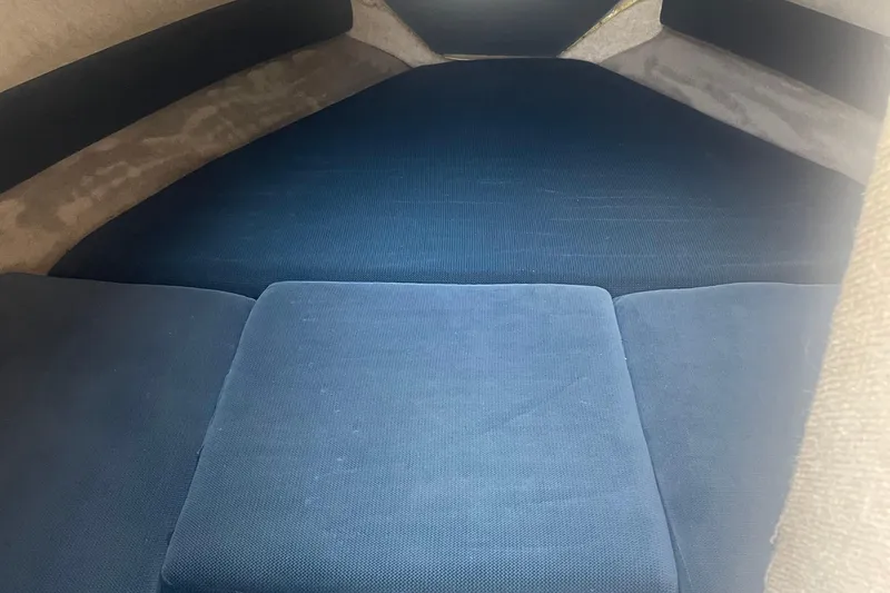 Slide: The Image of Interior cabin of a 1999 Bryant 214 Cuddy boat with blue cushions. - 10