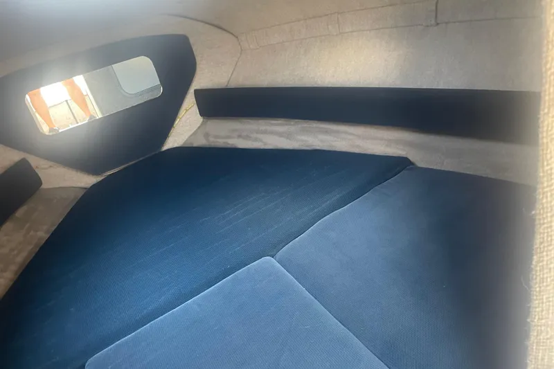 Slide: The Image of Interior cabin of a 1999 Bryant 214 Cuddy boat with blue cushions. - 11