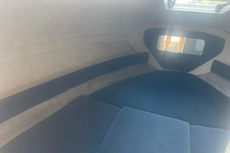 Slide: The Image of Interior cabin of a 1999 Bryant 214 Cuddy boat with blue cushions. - 7
