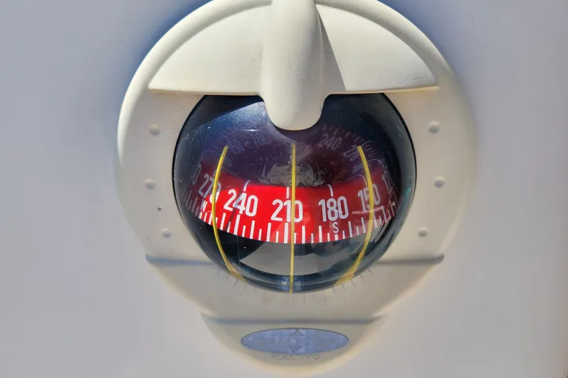 Slide: The Image of Compass on 2004 Alerion Express 28 sailboat, displaying cardinal directions. - 16