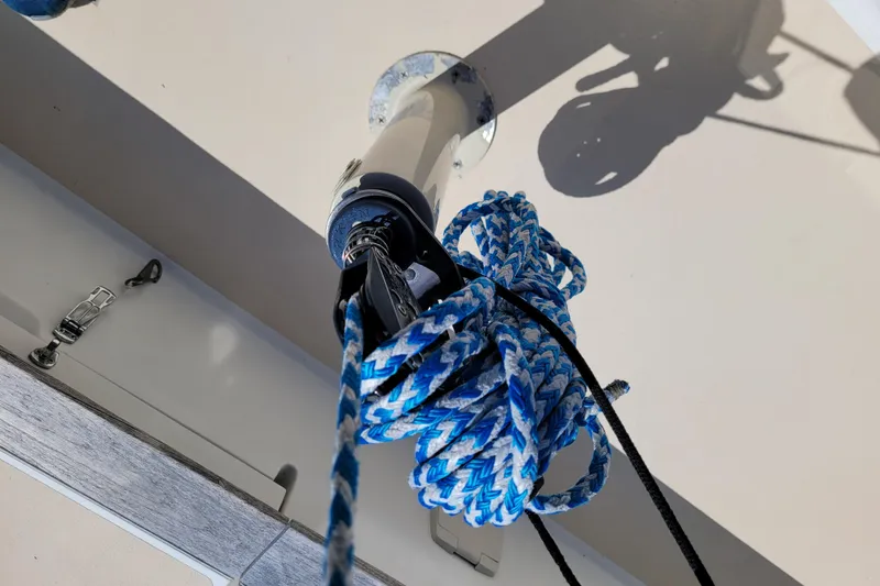 Slide: The Image of Close-up of a 2004 Alerion Express 28 sailboat rigging with blue and white rope. - 21