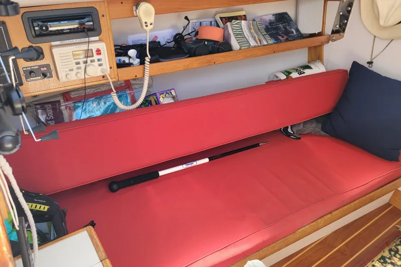 Slide: The Image of Interior of a 2004 Alerion Express 28 sailboat with red seating and navigation equipment. - 25
