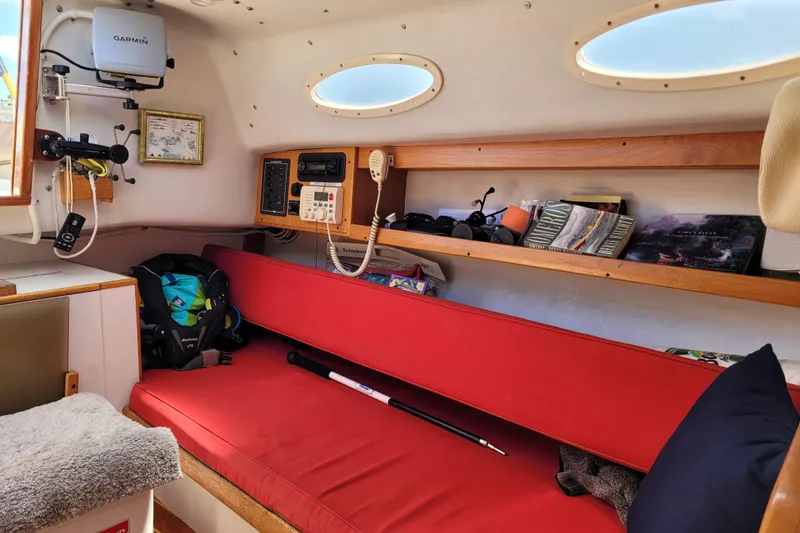 Slide: The Image of Interior of 2004 Alerion Express 28 sailboat with red seating and navigation equipment. - 27