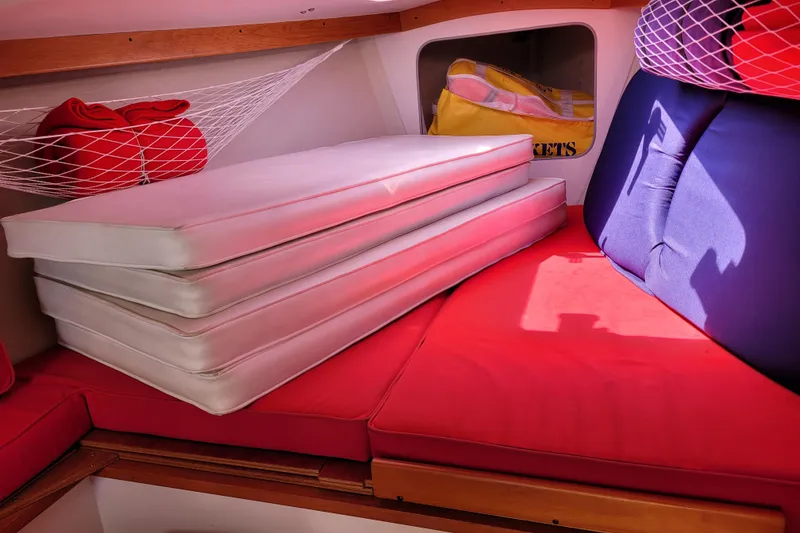 Slide: The Image of Interior of a 2004 Alerion Express 28 sailboat with red and white cushions. - 28