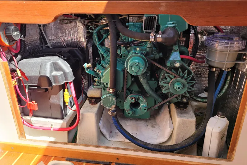Slide: The Image of Engine compartment of a 2004 Alerion Express 28 sailboat, featuring a green marine engine. - 32