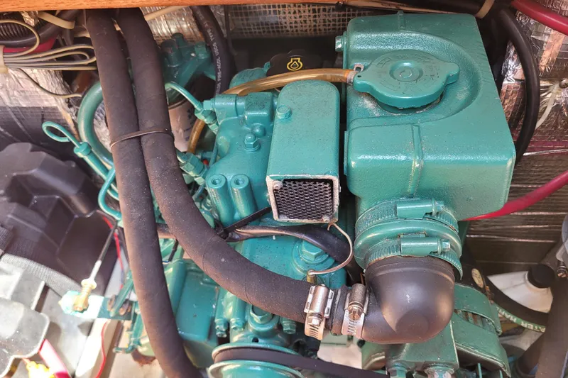 Slide: The Image of Engine compartment of a 2004 Alerion Express 28 sailboat, featuring a green marine engine. - 33