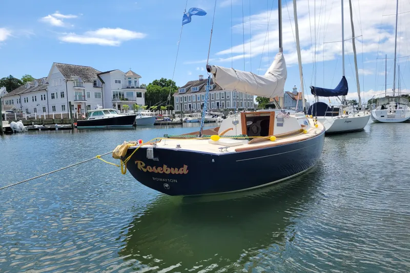 Slide: The Image of Alerion Express 28 sailboat docked in a scenic marina, 2004 model. - 6