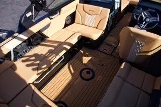 Slide: The Image of 2025 MasterCraft XT23 boat interior with luxurious tan seating and sleek design. - 10