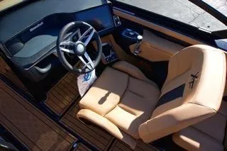 Slide: The Image of 2025 MasterCraft XT23 boat interior with luxury seating and modern dashboard. - 11