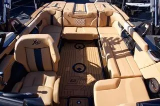 Slide: The Image of 2025 MasterCraft XT23 boat interior with luxurious tan seating and modern design. - 8