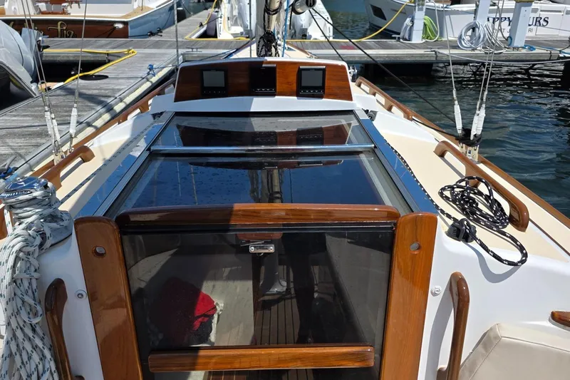 Slide: The Image of Cockpit of 2020 Alerion Express 33 sailboat with wooden trim and docked at marina. - 13