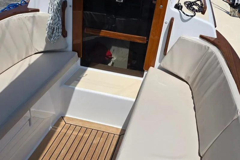Slide: The Image of Cockpit of 2020 Alerion Express 33 sailboat with cushioned seating and wooden accents. - 15