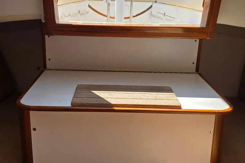 Slide: The Image of Interior of 2020 Alerion Express 33 sailboat with wooden accents and sunlight. - 17