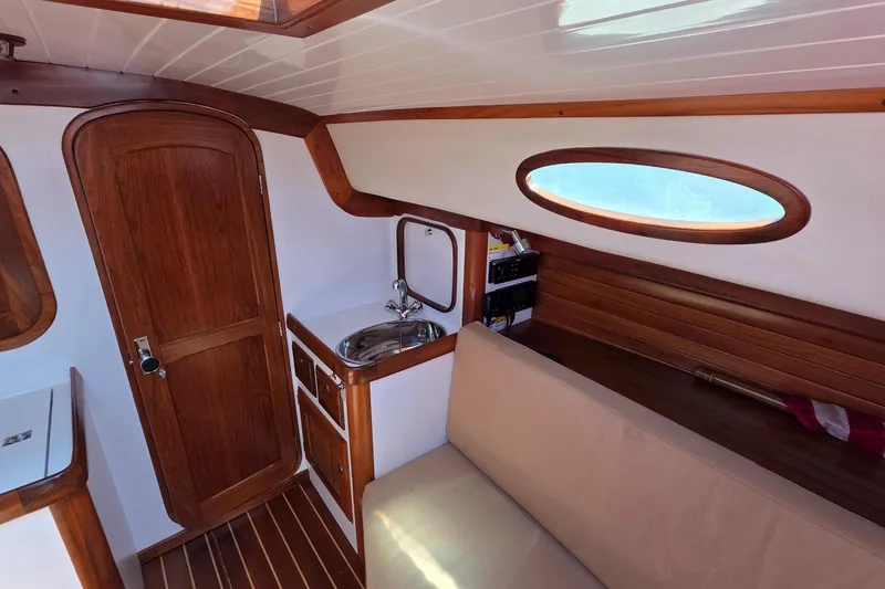 Slide: The Image of Interior of 2020 Alerion Express 33 sailboat with wooden finishes and compact sink area. - 21