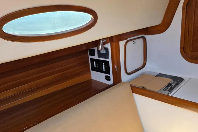 Slide: The Image of Interior of 2020 Alerion Express 33 sailboat with wood accents and oval window. - 22