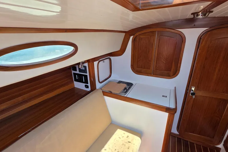 Slide: The Image of Interior of 2020 Alerion Express 33 sailboat with wooden cabinetry and seating. - 23