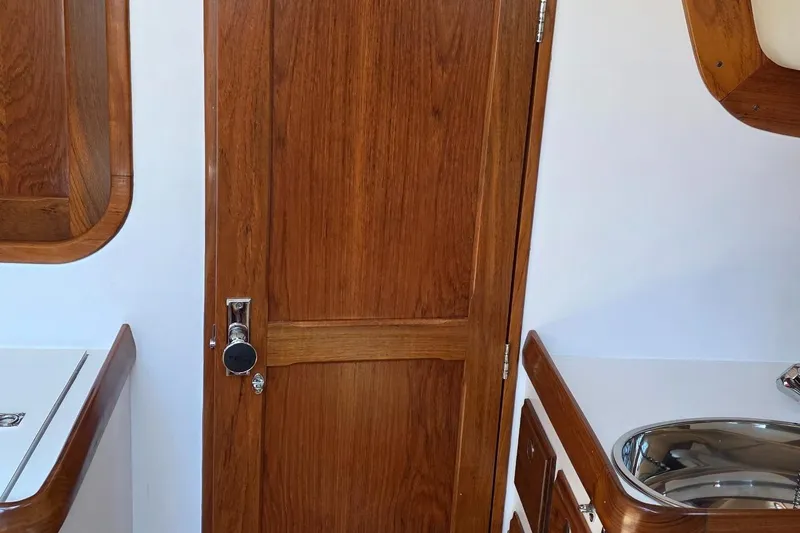 Slide: The Image of Interior of 2020 Alerion Express 33 sailboat with wooden door and cabinetry. - 24