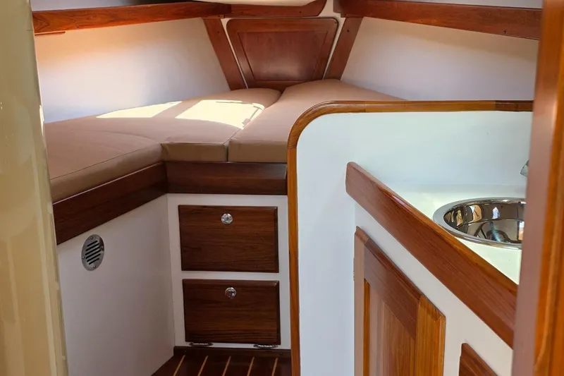 Slide: The Image of Interior of 2020 Alerion Express 33 sailboat with wood finish and cozy sleeping area. - 25
