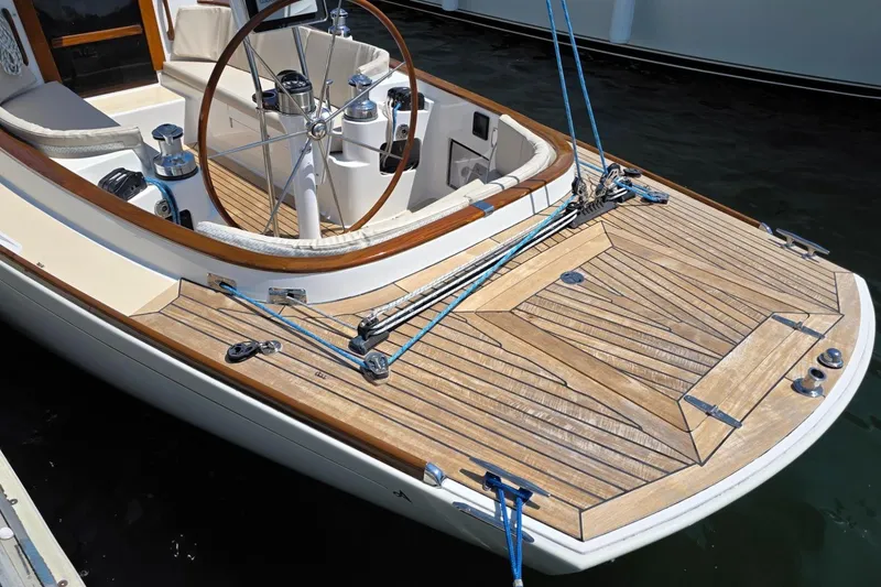 Slide: The Image of Alerion Express 33 sailboat cockpit with wooden deck and steering wheel, 2020 model. - 4