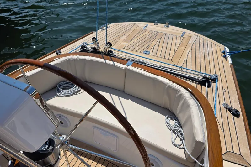 Slide: The Image of Cockpit of 2020 Alerion Express 33 sailboat with wooden deck and cushioned seating. - 6