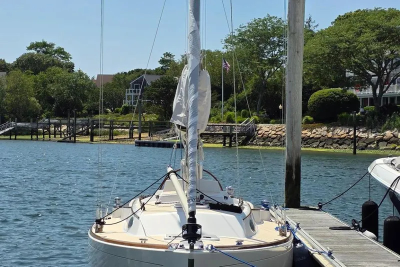 Slide: The Image of Alerion Express 33 sailboat docked by a scenic waterfront, 2020 model. - 8