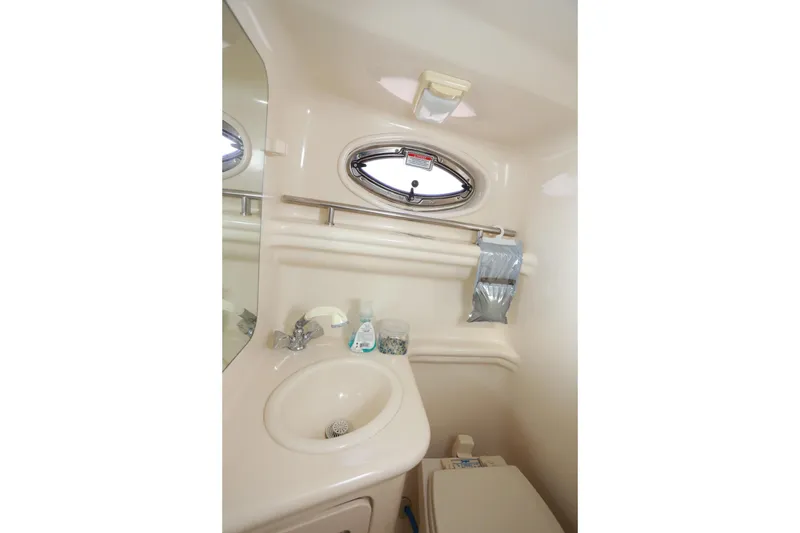 Slide: The Image of 2005 Sea Ray Sundancer 260 interior with open mini fridge and countertop. - 10