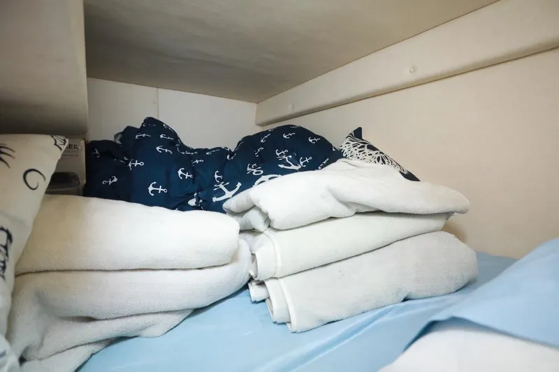 Slide: The Image of Cozy cabin interior of 2005 Sea Ray Sundancer 260 with nautical-themed bedding. - 13