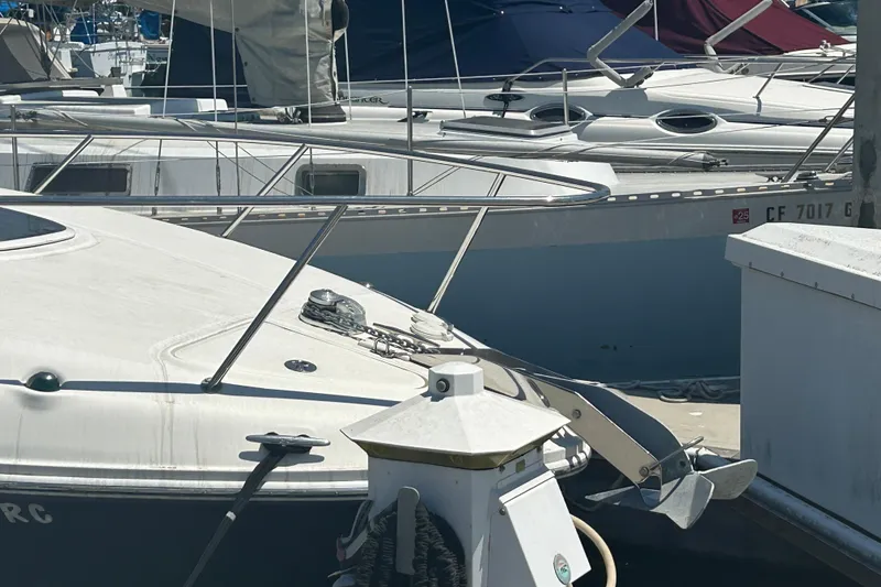 Slide: The Image of 2005 Sea Ray 260 Sundancer docked in a marina with cityscape background. - 2