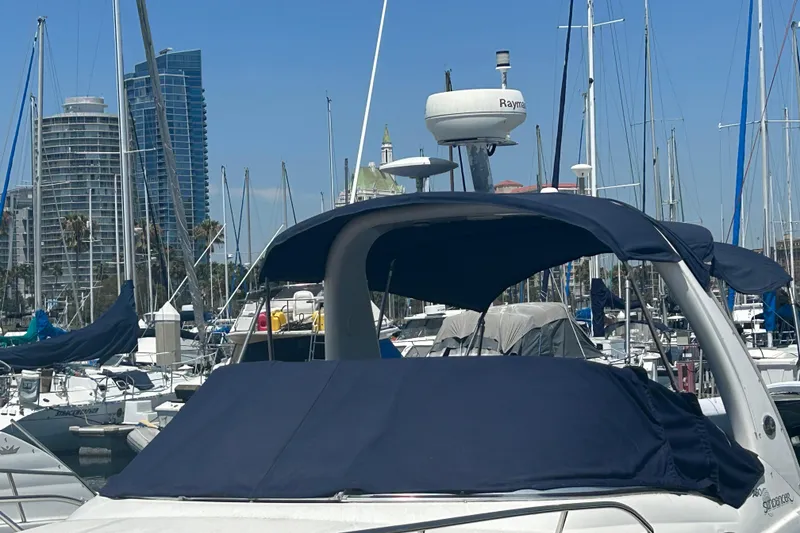 Slide: The Image of 2005 Sea Ray Sundancer 260 boat interior with seating, docked at marina. - 4