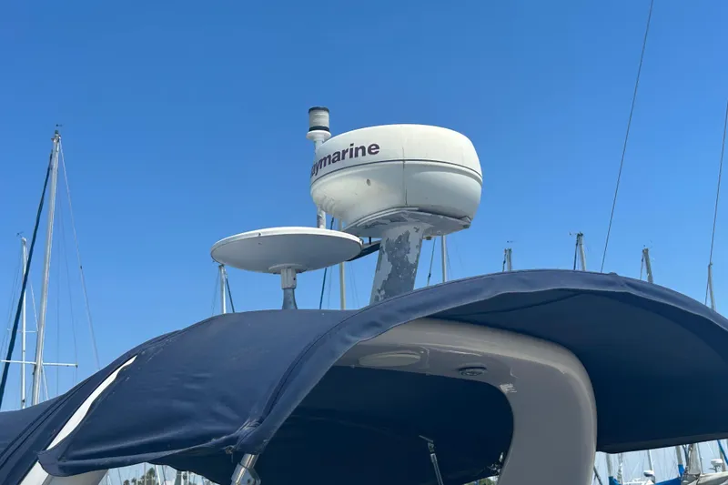 Slide: The Image of 2005 Sea Ray 260 Sundancer with radar equipment against a clear blue sky. - 6