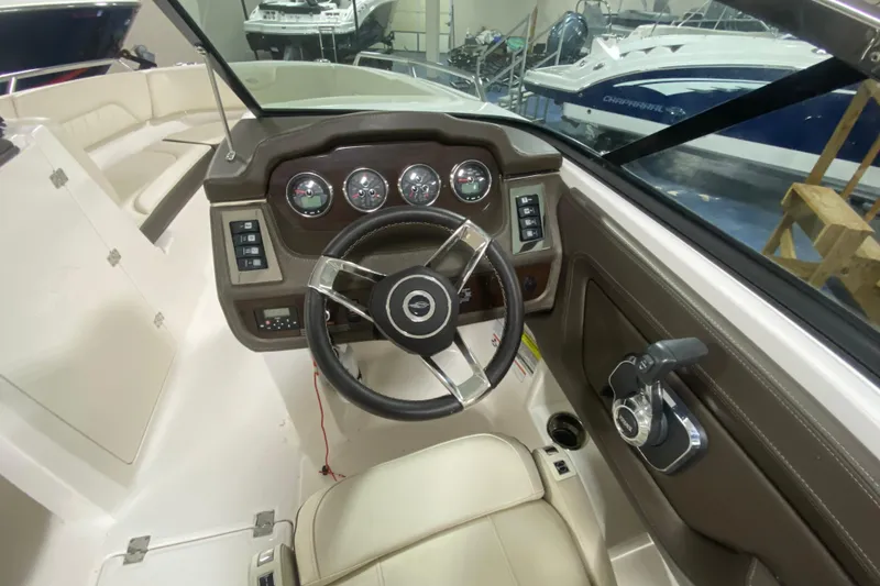 Slide: The Image of 2020 Chaparral 237 SSX boat dashboard with steering wheel and control panel. - 4