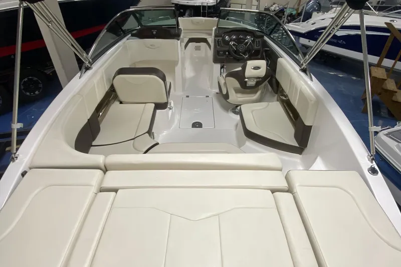 Slide: The Image of 2020 Chaparral 237 SSX boat interior with beige seating and modern dashboard. - 8