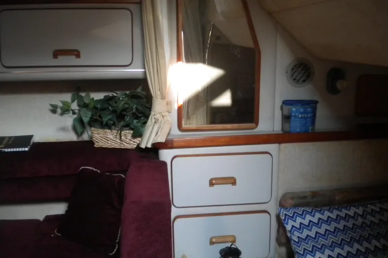 Slide: The Image of Interior of 1990 Sea Ray 310 Sundancer with seating, storage, and decor elements. - 10