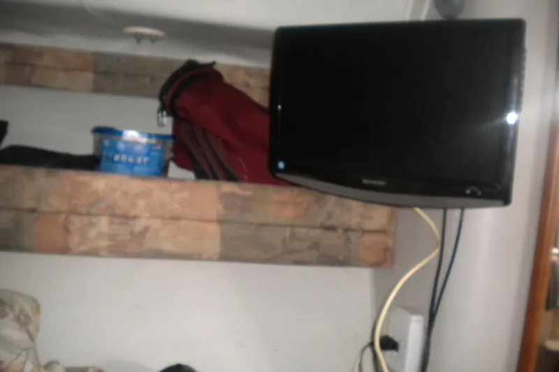 Slide: The Image of Interior of 1990 Sea Ray 310 Sundancer with TV and storage shelves. - 18