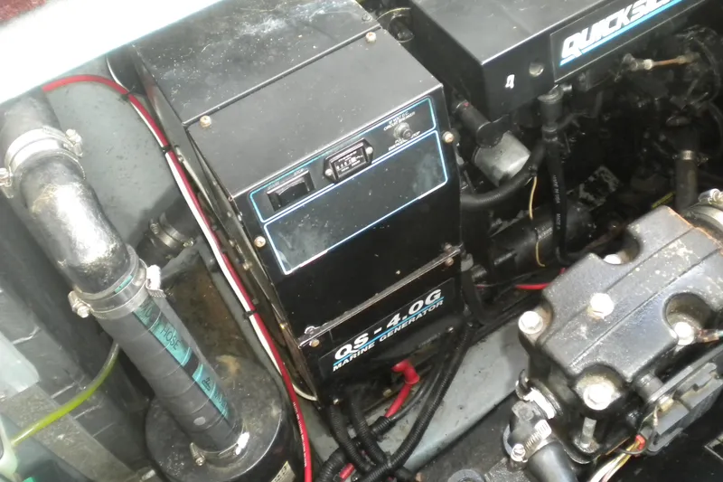 Slide: The Image of Engine compartment of a 1990 Sea Ray 310 Sundancer with marine generator and piping. - 22