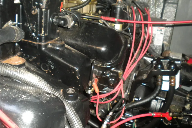 Slide: The Image of Engine components of a 1990 Sea Ray 310 Sundancer with visible wiring and hoses. - 24