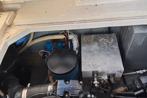 Slide: The Image of Engine compartment of a 1990 Sea Ray 310 Sundancer boat, showing mechanical components. - 25