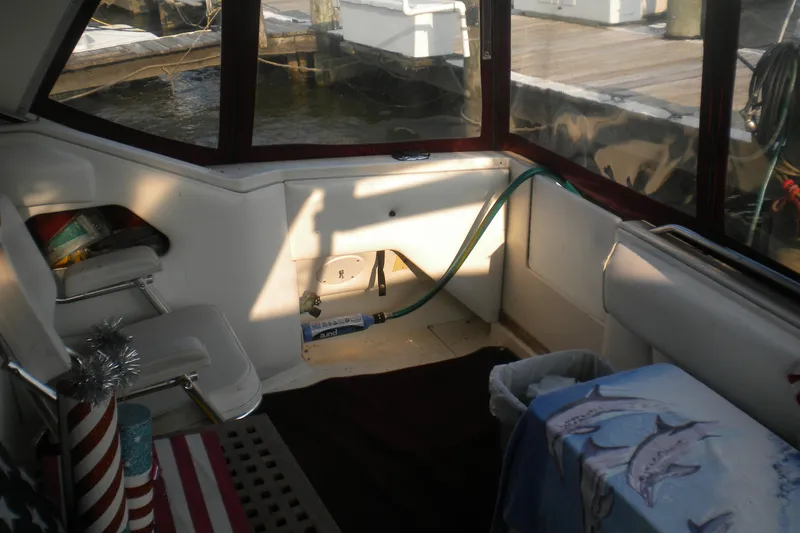 Slide: The Image of Interior of a 1990 Sea Ray 310 Sundancer boat with dockside view. - 5