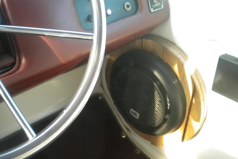 Slide: The Image of Steering wheel and speaker on 1990 Sea Ray 310 Sundancer boat dashboard. - 8