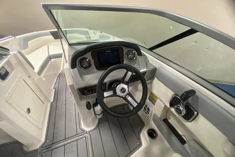 Slide: The Image of 2023 Chaparral 21 SSi boat interior with steering wheel and dashboard controls. - 4