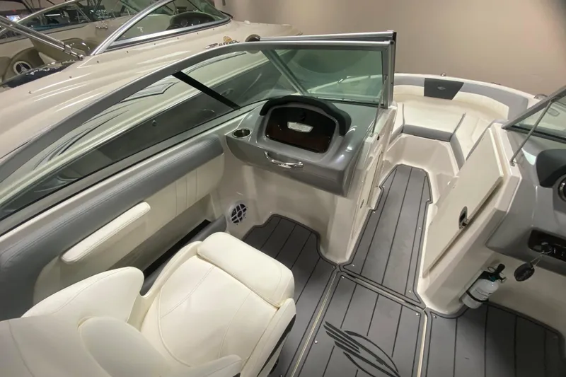 Slide: The Image of 2023 Chaparral 21 SSi boat interior with sleek seating and modern dashboard design. - 5