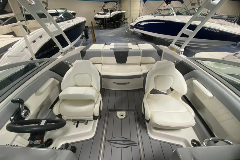 Slide: The Image of 2023 Chaparral 21 SSi boat interior with white seating and modern design. - 6