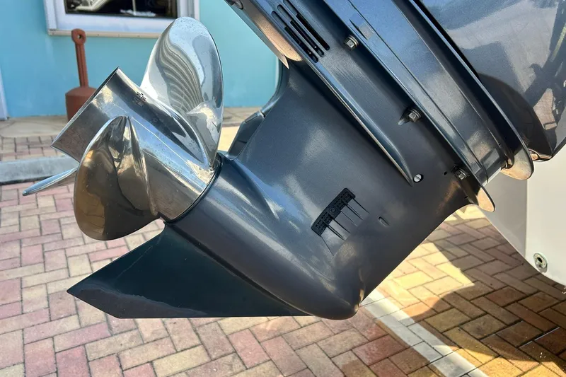 Slide: The Image of 2019 Sea Hunt Gamefish 27 propeller detail, shiny metal finish, outdoor setting. - 10