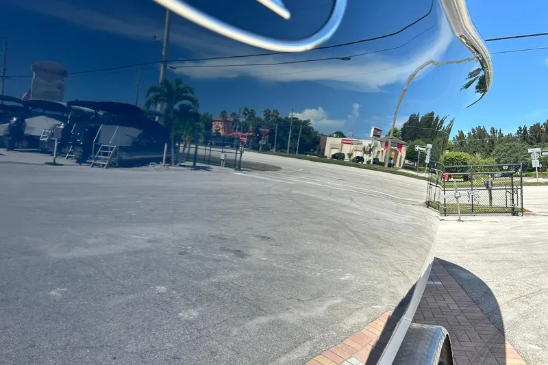 Slide: The Image of Reflection on 2019 Sea Hunt Gamefish 27 boat hull in parking lot. - 14