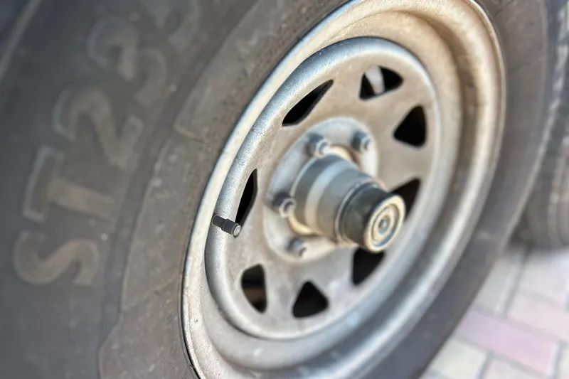 Slide: The Image of Close-up of a 2019 Sea Hunt Gamefish 27 trailer wheel and tire. - 15